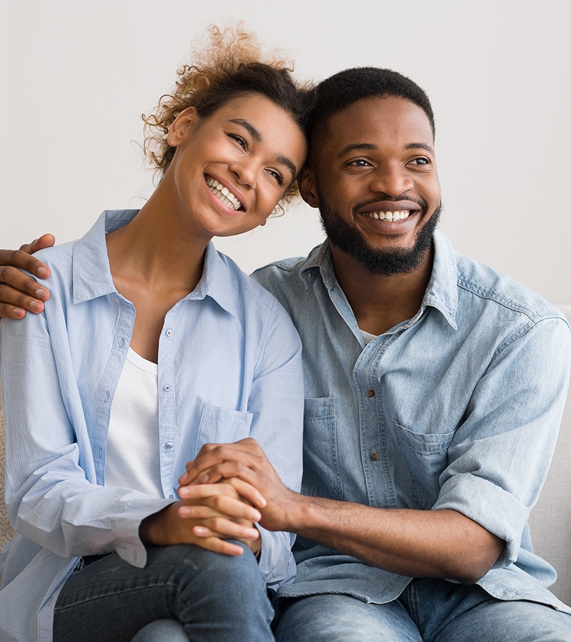 A smiling couple embracing, representing emotional well-being and healthy relationships